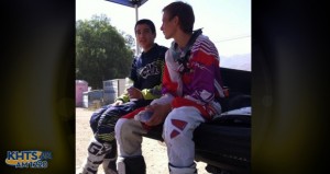Justin Covarrubias, left, a Canyon High junior who was seriously hurt in a crash, sits with a friend next to a motocross race track