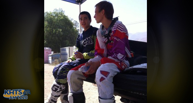 Justin Covarrubias, left, a Canyon High junior who was seriously hurt in a crash, sits with a friend next to a motocross race track