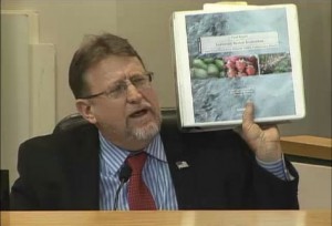 Santa Clarita City Councilman TimBen Boydston holds up a binder with a chloride study