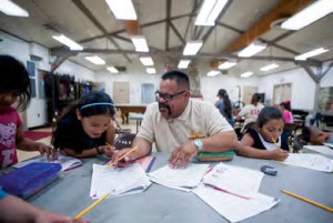 Jaime Briano helps tutor children after school at Val Verde Park through the Sheriff's YAL.