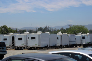 Paramount production trailers line the vacant lot at the corner of Lyons Avenue and Main Street. Photo by Melissa Lampert.