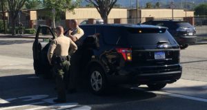 Deputies block off a street during the containment