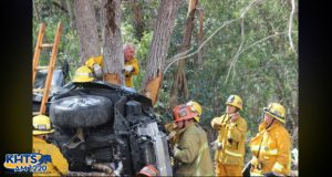 Firefighters work to free a trapped party from the overturned vehicle. Photo by Mauricio La Plante