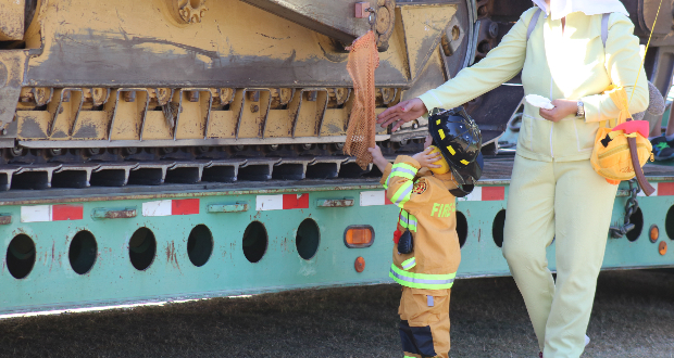 A picture of a child touching a bulldozer