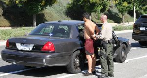 A picture of the suspect being taken into custody