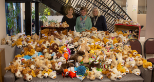 Patricia Aidem, Cheryl Jones, and Sherri Mendelson surrounded by the donated plush animals.