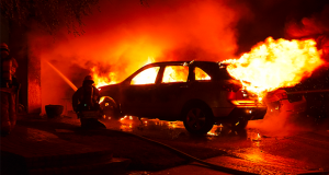 One of the vehicles burning in the driveway of the residence on Zimmerman Pl.
