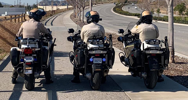 Three motorcycle deputies parked on the bike route in Saugus.