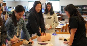 Valencia High School Medical Science Academy Students use a pressure-sensing device to practice applying pressure to wounds.