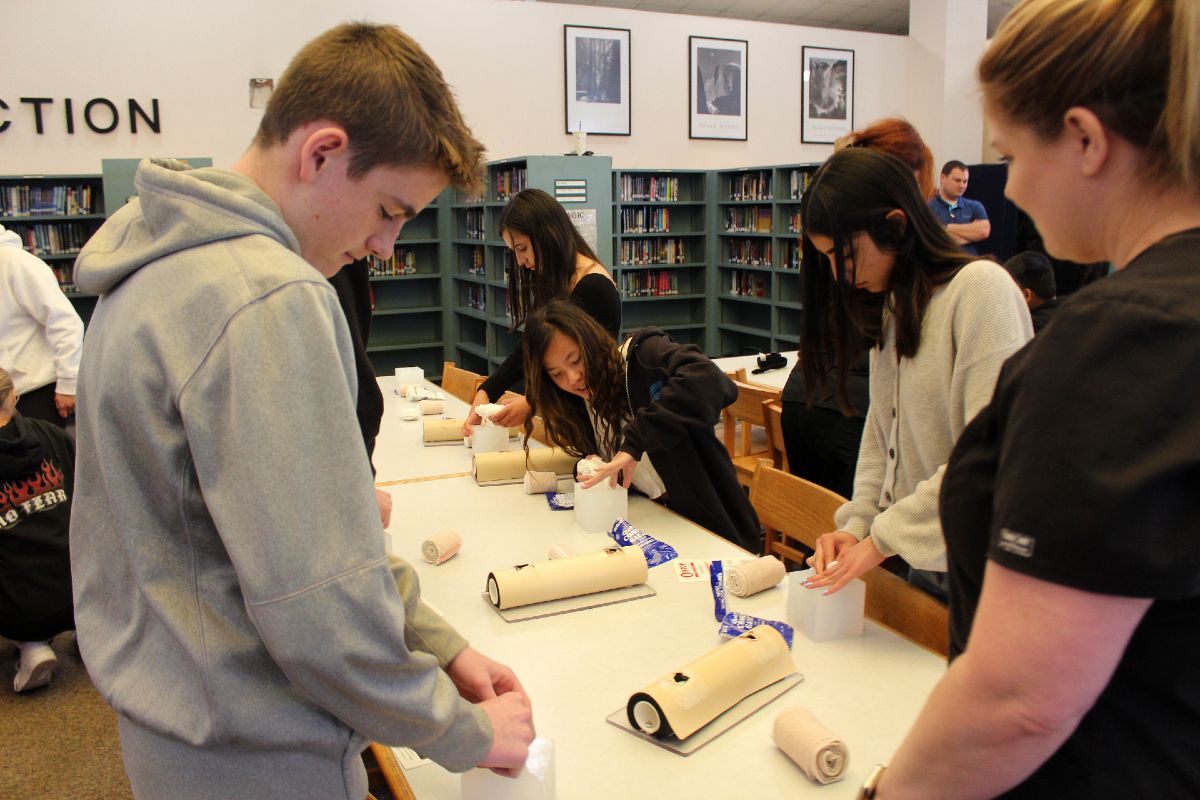 Valencia High School students practice packing wounds under the tutelage of a Henry Mayo Newhall Trauma Nurse.