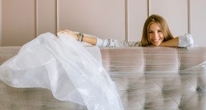 Woman Smiling Behind the Headboard