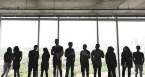 From Amarakesh website: a group of people stand in silhouette against bright, ceiling length windows
