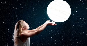Girl holding moon in her hands