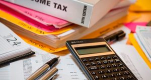 Income tax papers and calculator on desk