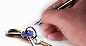 Writing on paper next to keys