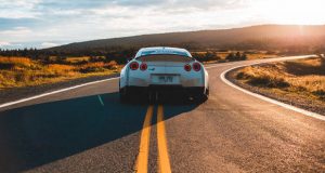 Image of back of Porsche on road
