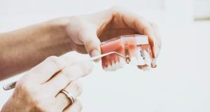 Woman holding new dentures
