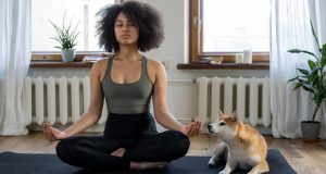 woman meditating with her dog