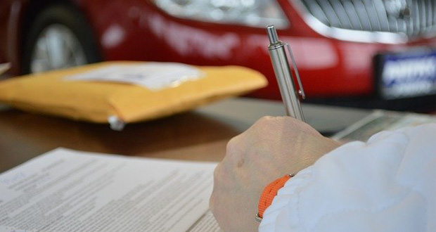Man signing car loan