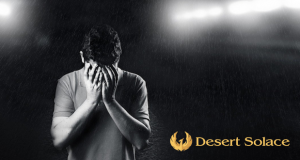 Desert Solace Logo on an image of a man with his head in his hands
