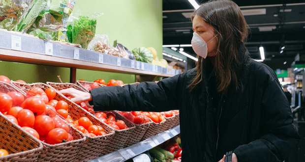 Woman in grocery store wearing mask