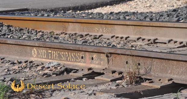 Desert Solace - The Social Aspect Of Addiction Treatment: Setting Boundaries - A railroad track with 'no trespassing' written on it in block letters.