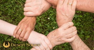 Desert Solace - Addiction Recovery Facility Explains Why Families Also Need Support - A circle of hands grasping one another, two of which are adorned with wedding rings