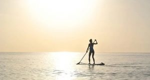 Paddle boarding in sunrise