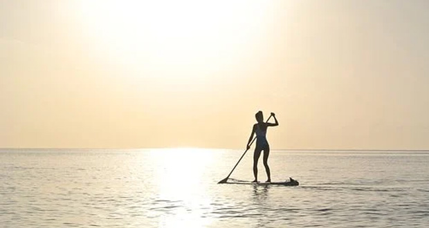 Paddle boarding in sunrise