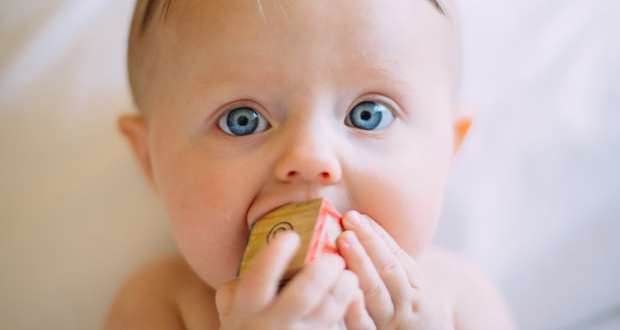 Baby with block in mouth