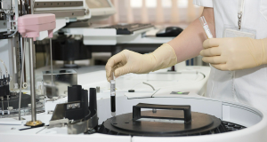 A medical professional holding vials in a research lab setting.