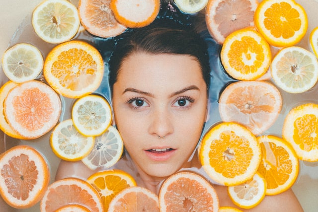 Woman surrounded by sliced lemons