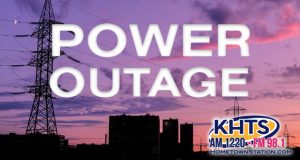 Power outage graphic slider, powerlines over a cityscape under a purple/orange sky due to a sunrise or sunset