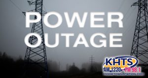 Power outage graphic slider, high tension power lines looming over a neighborhood in thick fog
