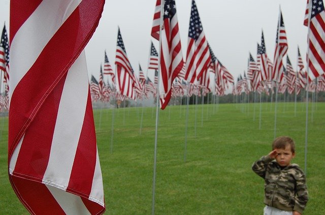 Little boy saluting flag