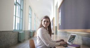Student typing on laptop
