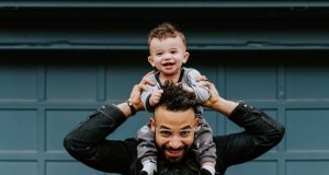 Kid on dad's shoulders