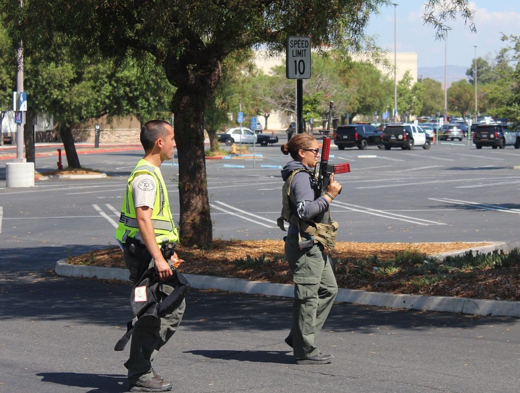 Two deputies walk away from the old Sears building