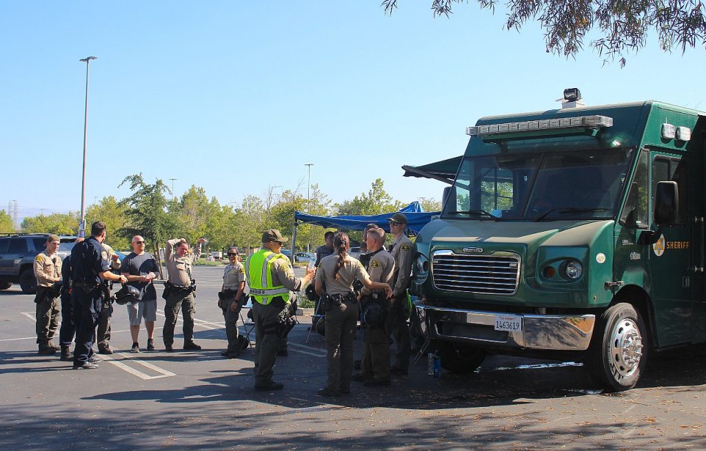Deputies stand by a mobile command center