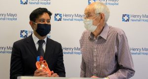 Dick Sears and Dr. Abhishek Sinha stand with a model of the heart during Tuesday's event.