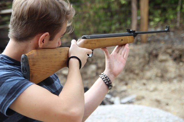 man shooting rifle