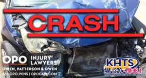 Crumpled bumper and hood of a blue sedan. "Crash" overlaid in red capital letters with the KHTS and OPO logo -- crash traffic collision