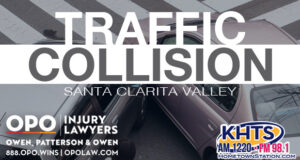 Two-car collision at an intersection. "Traffic Collision" overlaid in white capital letters with the KHTS and OPO logo -- crash traffic collision