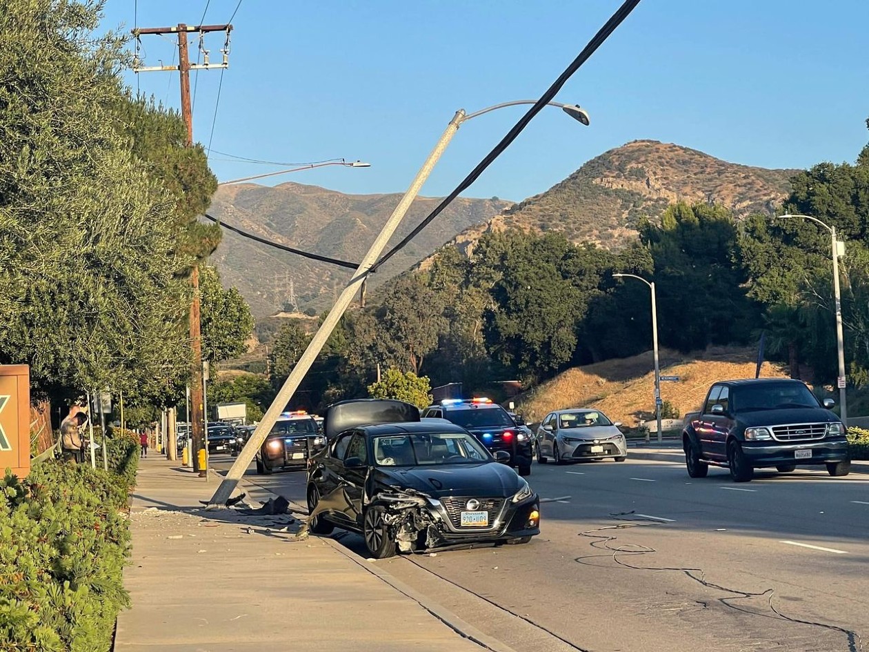 One Taken To Hospital, Traffic Impacted By Crash Into Light Pole